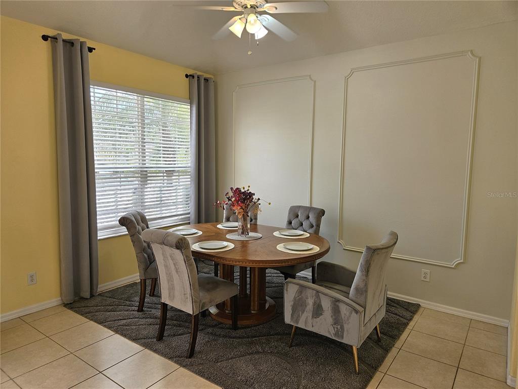 175 Braemar Avenue Venice, FL 34293 - Photo 4 of 40 a view of a dining room with furniture and a chandelier