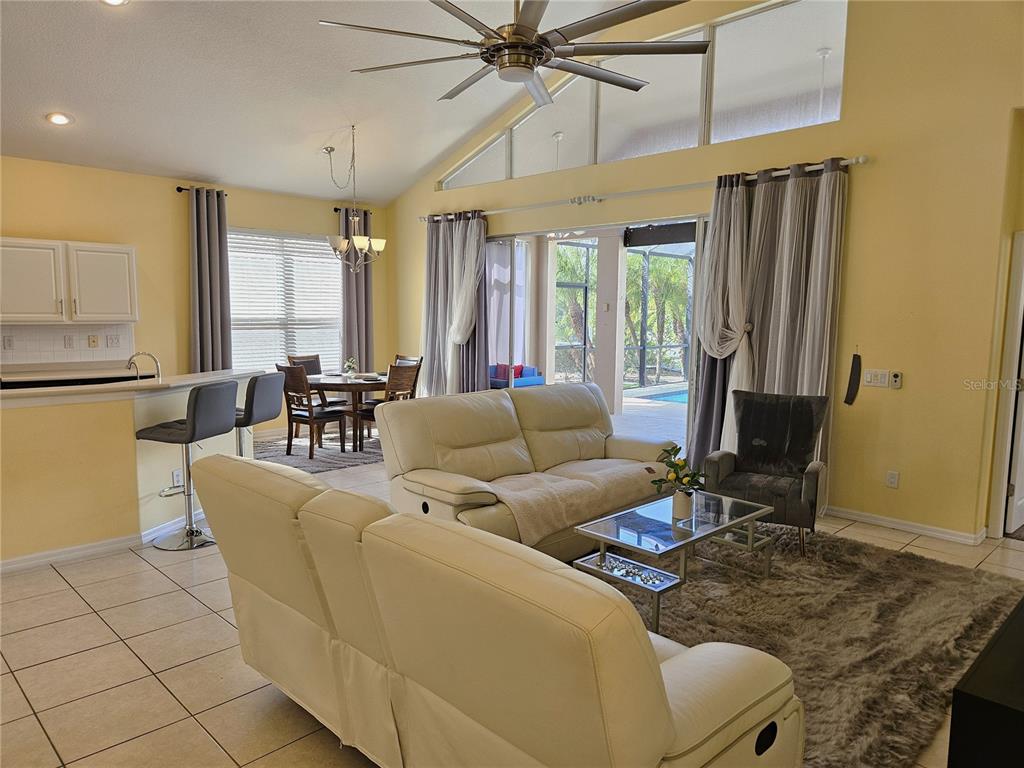 175 Braemar Avenue Venice, FL 34293 - Photo 7 of 40 a living room with furniture a fireplace and a flat screen tv