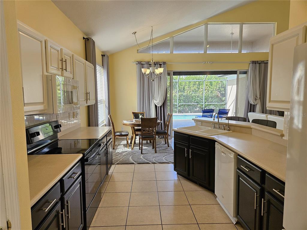 175 Braemar Avenue Venice, FL 34293 - Photo 10 of 40 a kitchen with a sink stove and cabinets
