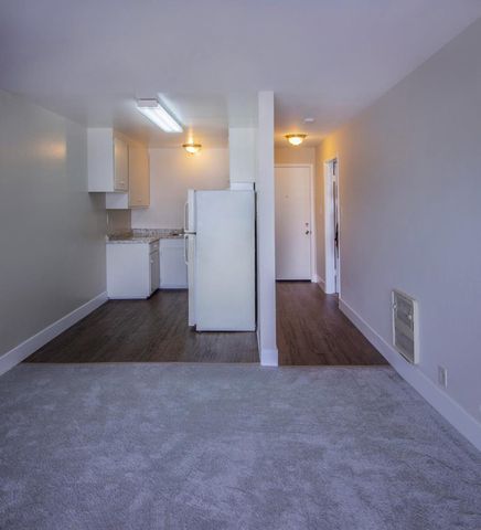 a view of a kitchen with a refrigerator and a cabinets