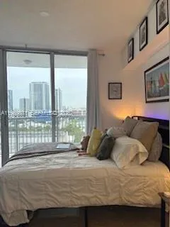 a bedroom with a bed and glass window