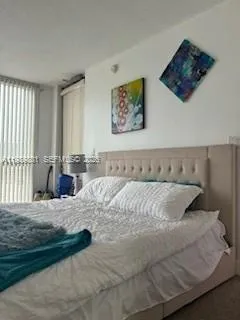 a bedroom with a large bed and a couch