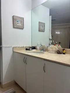a bathroom with a sink and a mirror