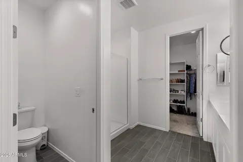 a view of a bathroom with a toilet and a shower