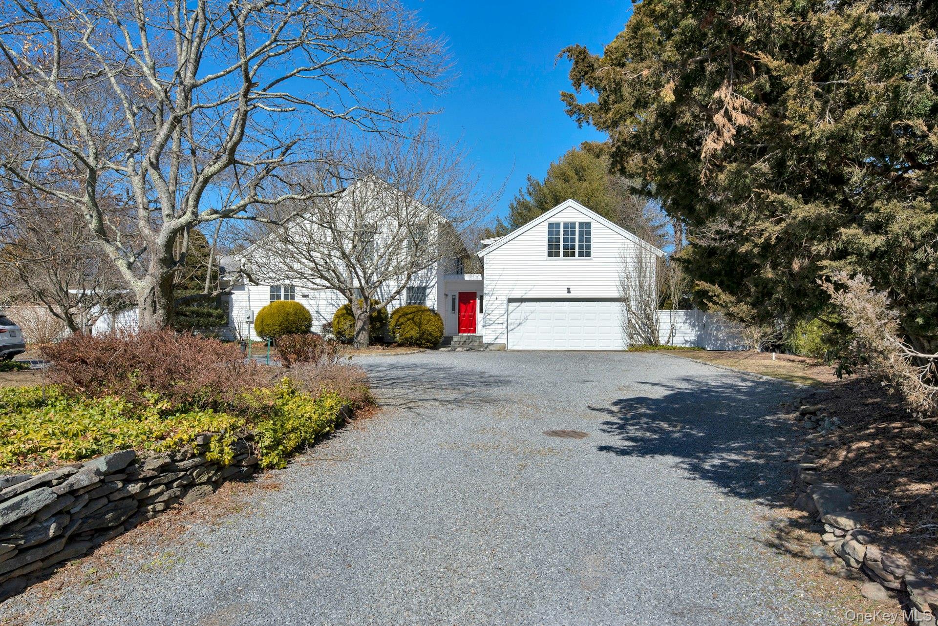 Exterior with circular driveway and front yard with 2 car garage