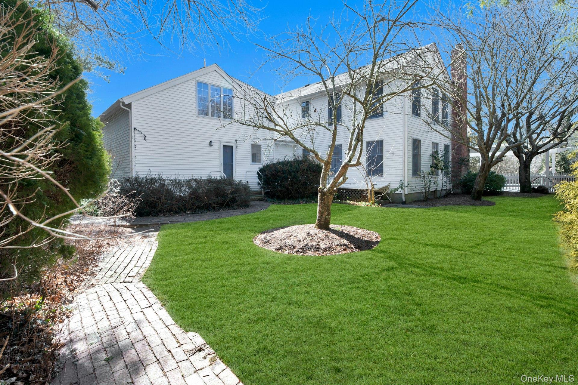 94 South Country Road Remsenburg, NY 11960 - Photo 20 of 40 Additional Backyard flanking Tennis Court, Pool, Backyard & Private Entrance to Mud Room/Laundry Room and Private Ensuite with Separate Entrance
