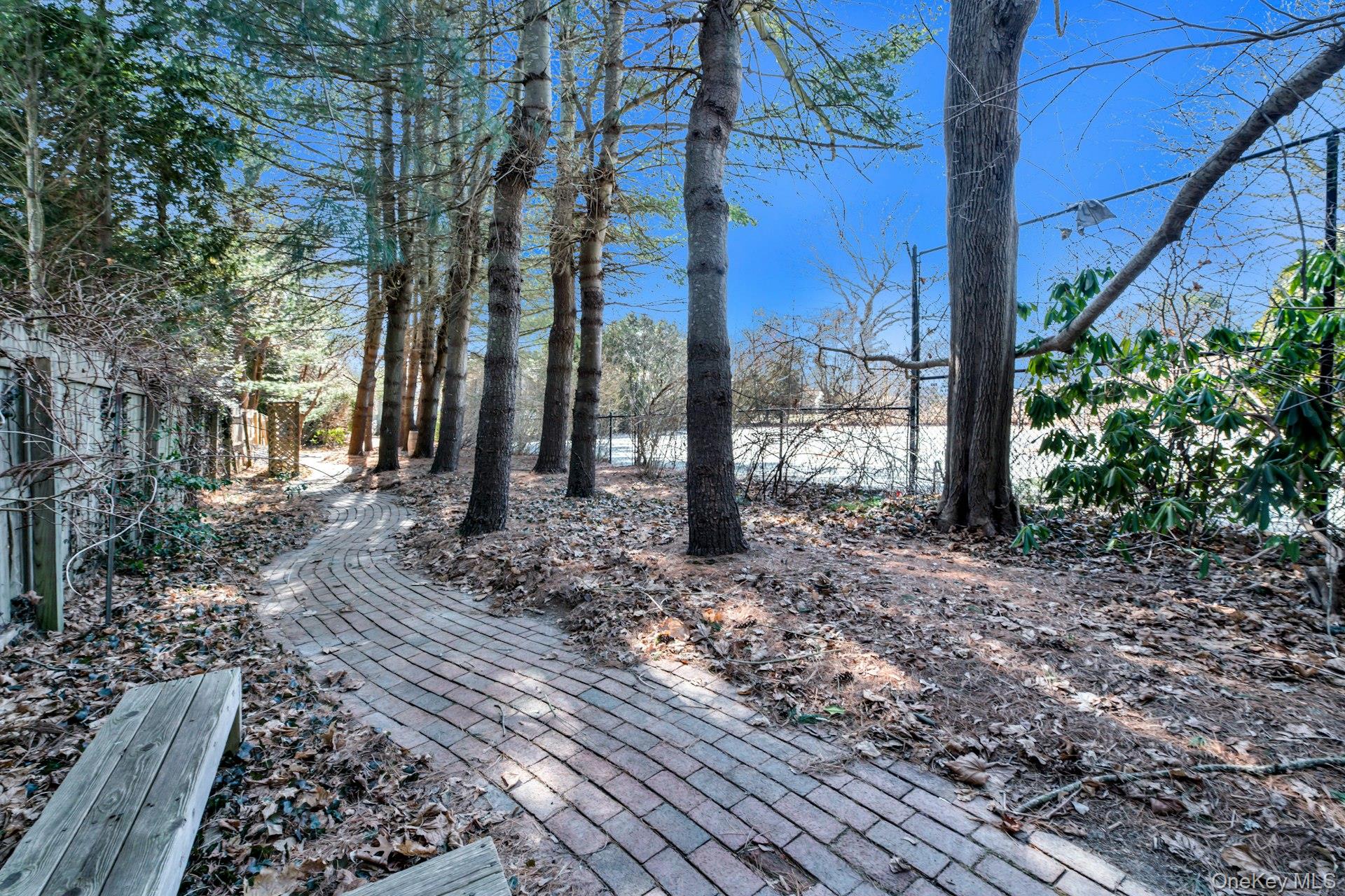 94 South Country Road Remsenburg, NY 11960 - Photo 21 of 40 Follow the Brick path to the Tennis Court from the Pool to Courtyard and Front Yard