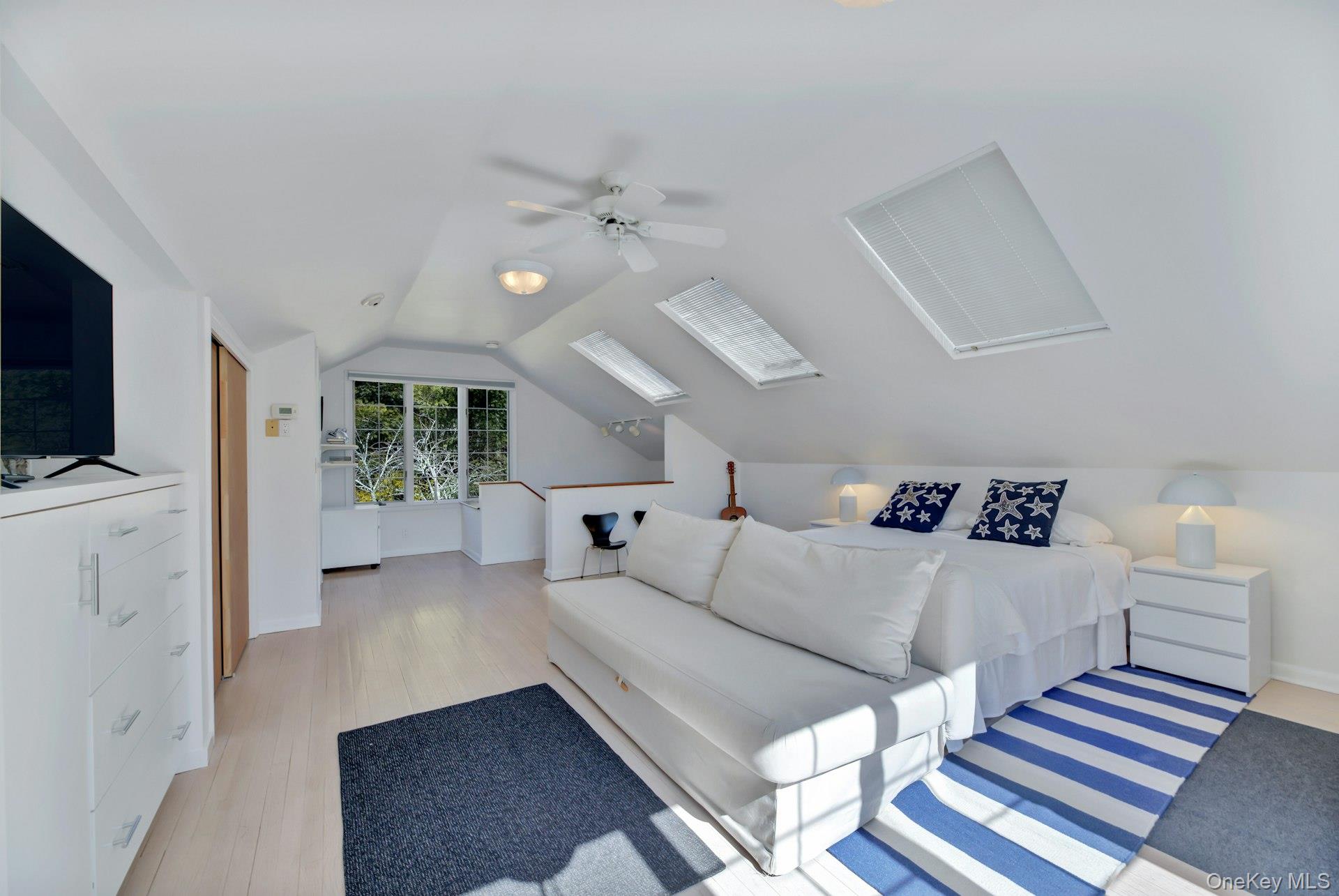 94 South Country Road Remsenburg, NY 11960 - Photo 23 of 40 Private en-suite queen bedroom with separate entrance to its own exterior living space and common backyard. Office area with en-suite bathroom and featuring a ceiling fan & vaulted ceiling.