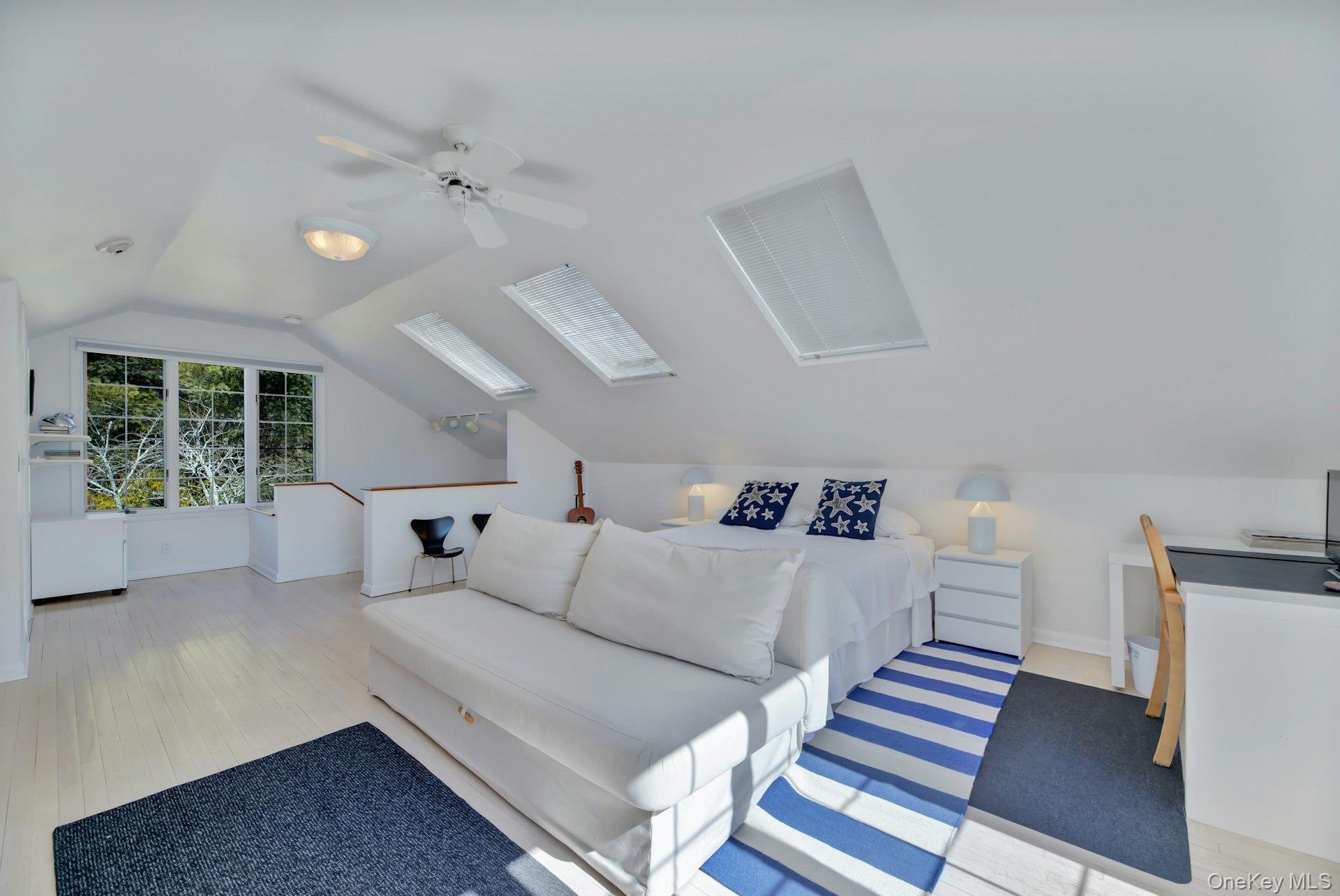 94 South Country Road Remsenburg, NY 11960 - Photo 26 of 40 Bedroom with focus on desk area with park like views lofted ceiling, ceiling fan, wood finished floors, and baseboards