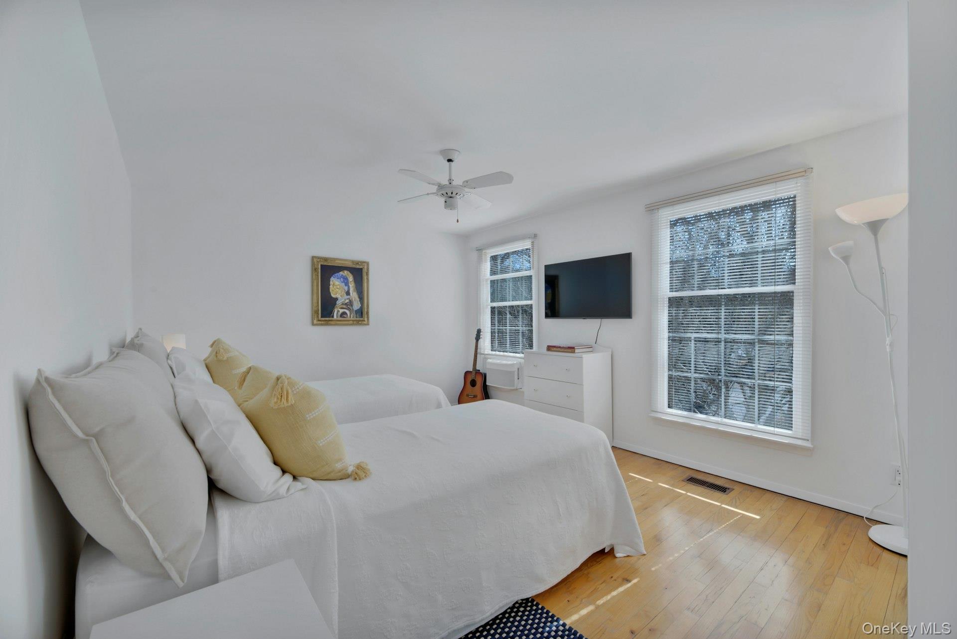 94 South Country Road Remsenburg, NY 11960 - Photo 27 of 40 2nd floor twin bedroom featuring ceiling fan and television
