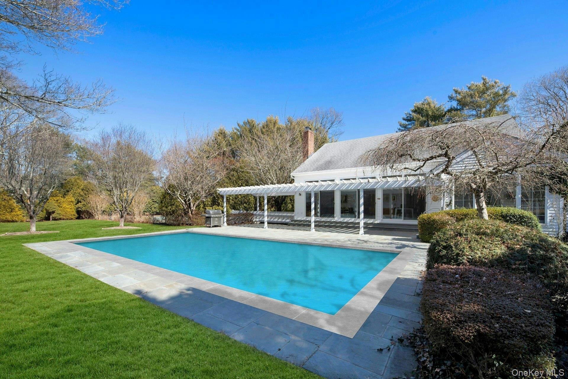 94 South Country Road Remsenburg, NY 11960 - Photo 37 of 40 Pool featuring a lawn, grilling area, a pergola and a patio