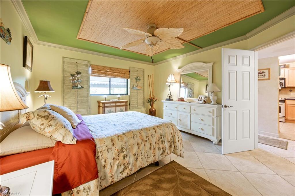 9395 Pennsylvania Avenue, Unit 3 Bonita Springs, FL 34135 - Photo 19 of 42 Tiled bedroom with ceiling fan, wooden ceiling, and ornamental molding