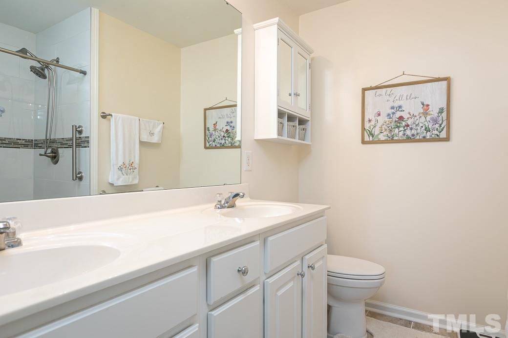 4834 Sir Duncan Way Raleigh, NC 27612 - Photo 15 of 27 Master Bath features dual vanity, brushed nickel, and tile floors.