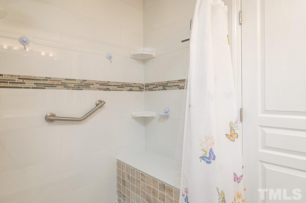 4834 Sir Duncan Way Raleigh, NC 27612 - Photo 16 of 27 Upgraded walk-in shower with gorgeous tile work and shower seat!