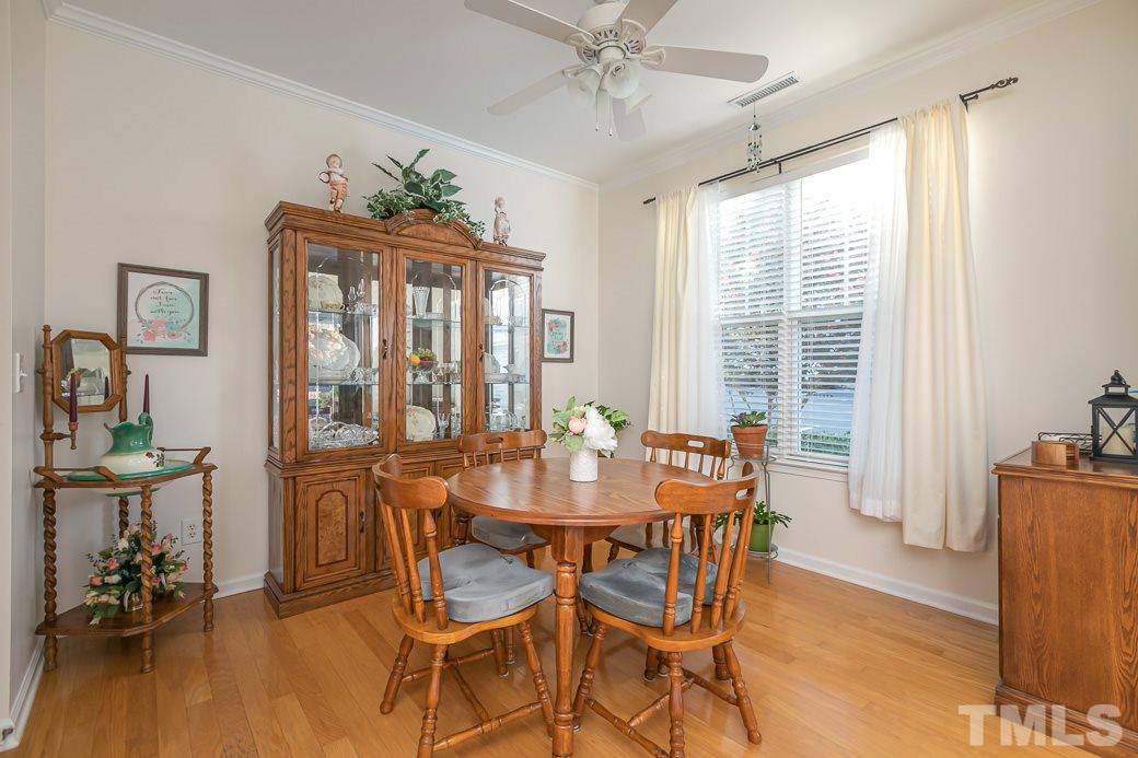 4834 Sir Duncan Way Raleigh, NC 27612 - Photo 4 of 27 Separate dining room with hardwoods and crown molding.