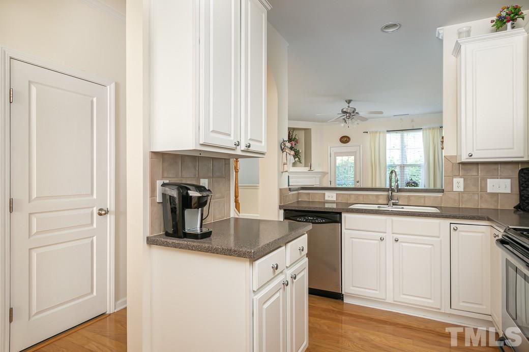 4834 Sir Duncan Way Raleigh, NC 27612 - Photo 7 of 27 Corian countertops and tile backsplash!