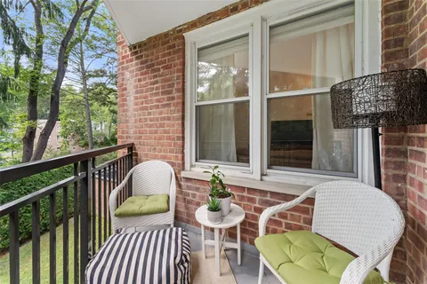 a view of a chairs and table in the balcony