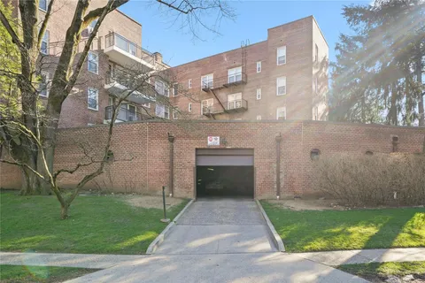 a front view of a building with garden
