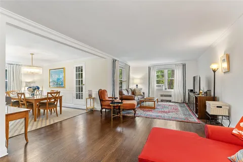 a living room with furniture wooden floor and a table