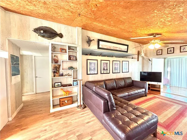 a living room with furniture cabinets and a table
