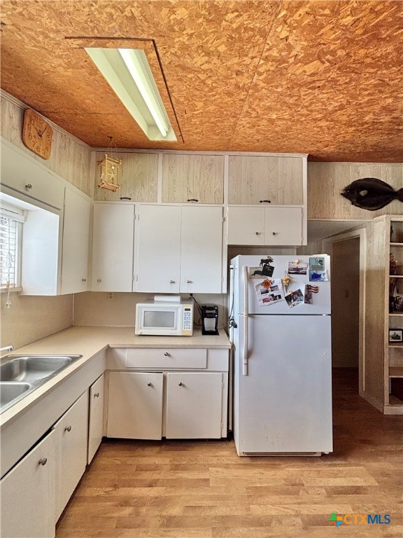 307 North 12th Port Port O'Connor, TX 77982 - Photo 13 of 45 a kitchen with a sink a refrigerator and window