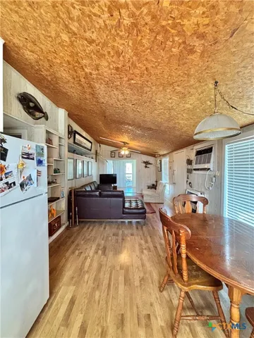 a living room with furniture and a table with kitchen view