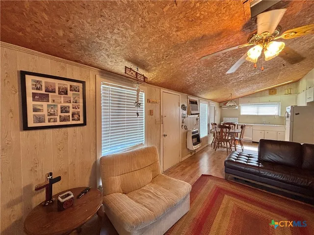 a view of a room with wooden floor