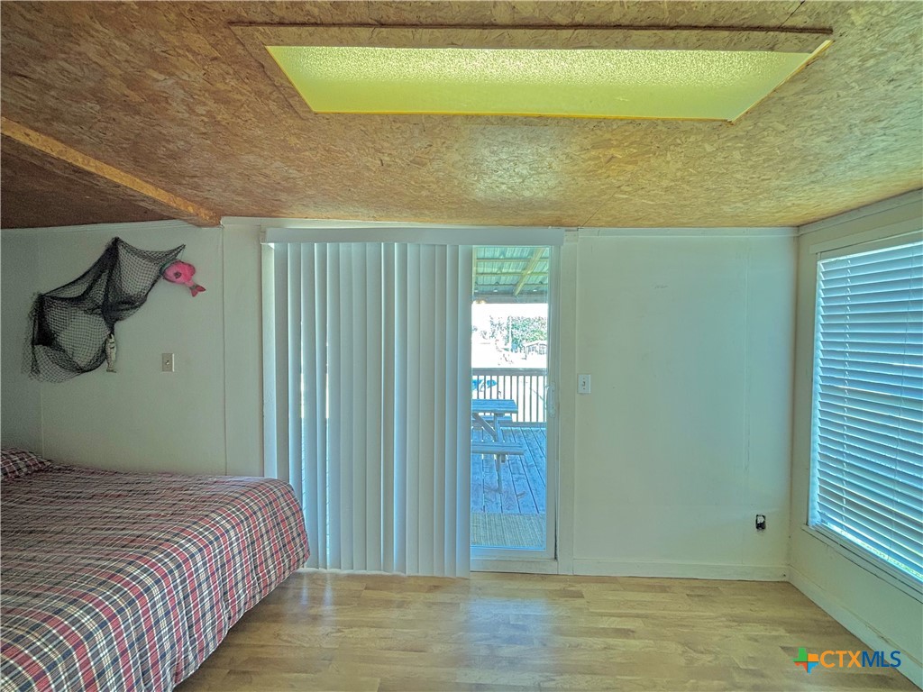 307 North 12th Port Port O'Connor, TX 77982 - Photo 23 of 45 a bedroom with a bed and a window