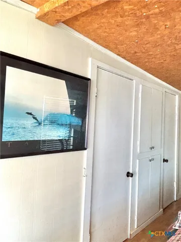 a view of a hallway to a bedroom