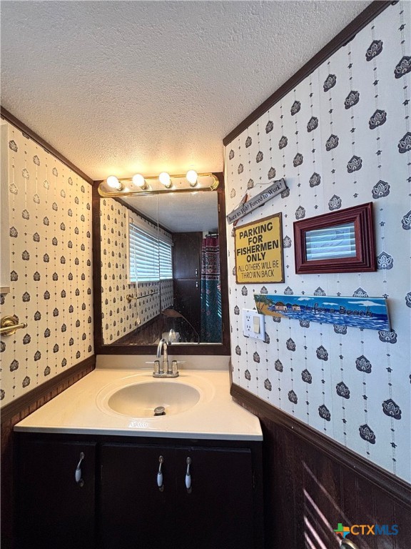 307 North 12th Port Port O'Connor, TX 77982 - Photo 30 of 45 a bathroom with a sink a mirror and shower