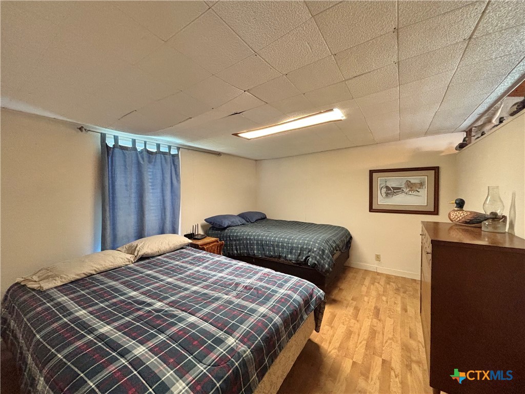 307 North 12th Port Port O'Connor, TX 77982 - Photo 36 of 45 a bedroom with a bed and a dresser