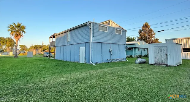 a swimming pool with a yard and wooden fence