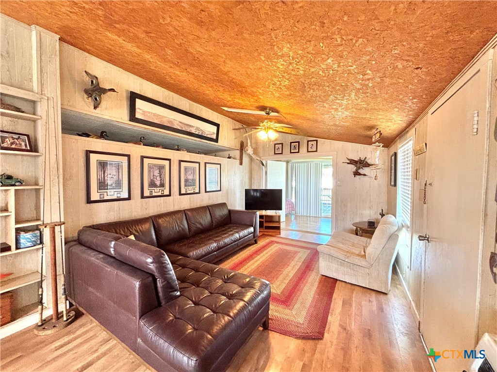 307 North 12th Port Port O'Connor, TX 77982 - Photo 6 of 45 a view of a patio with couches chairs and wooden floor