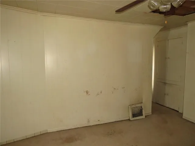 a white toilet sitting next to a sink and a mirror