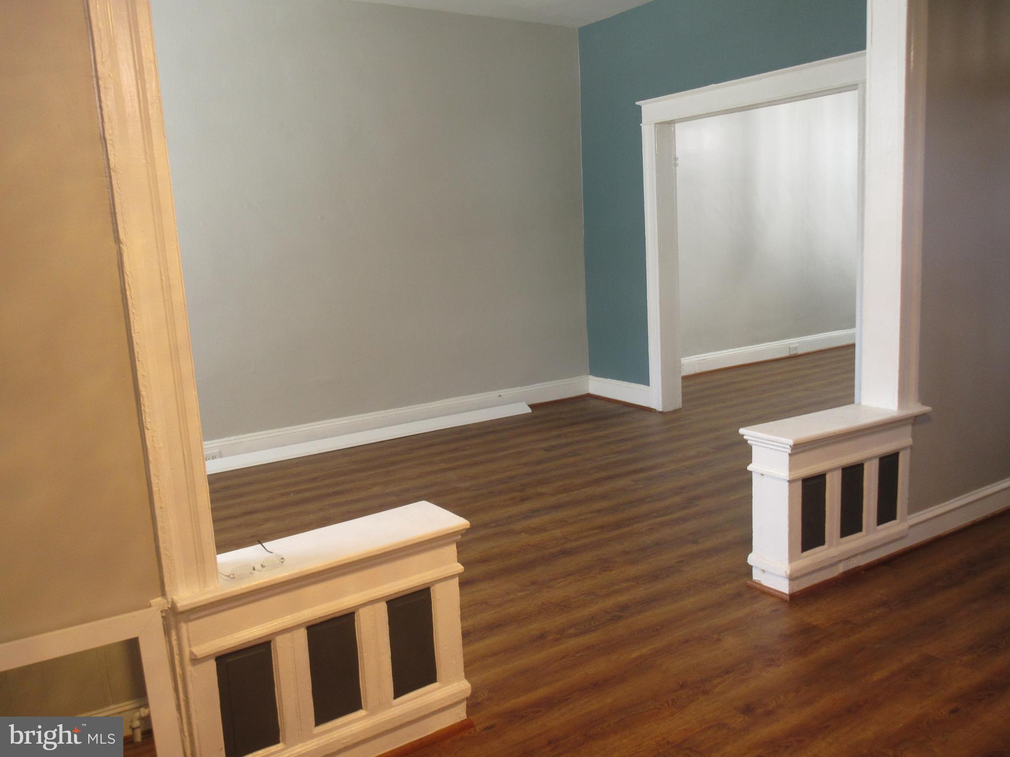 722 Edgewood Street Baltimore, MD 21229 - Photo 13 of 56 a view of an empty room with wooden floor and a window