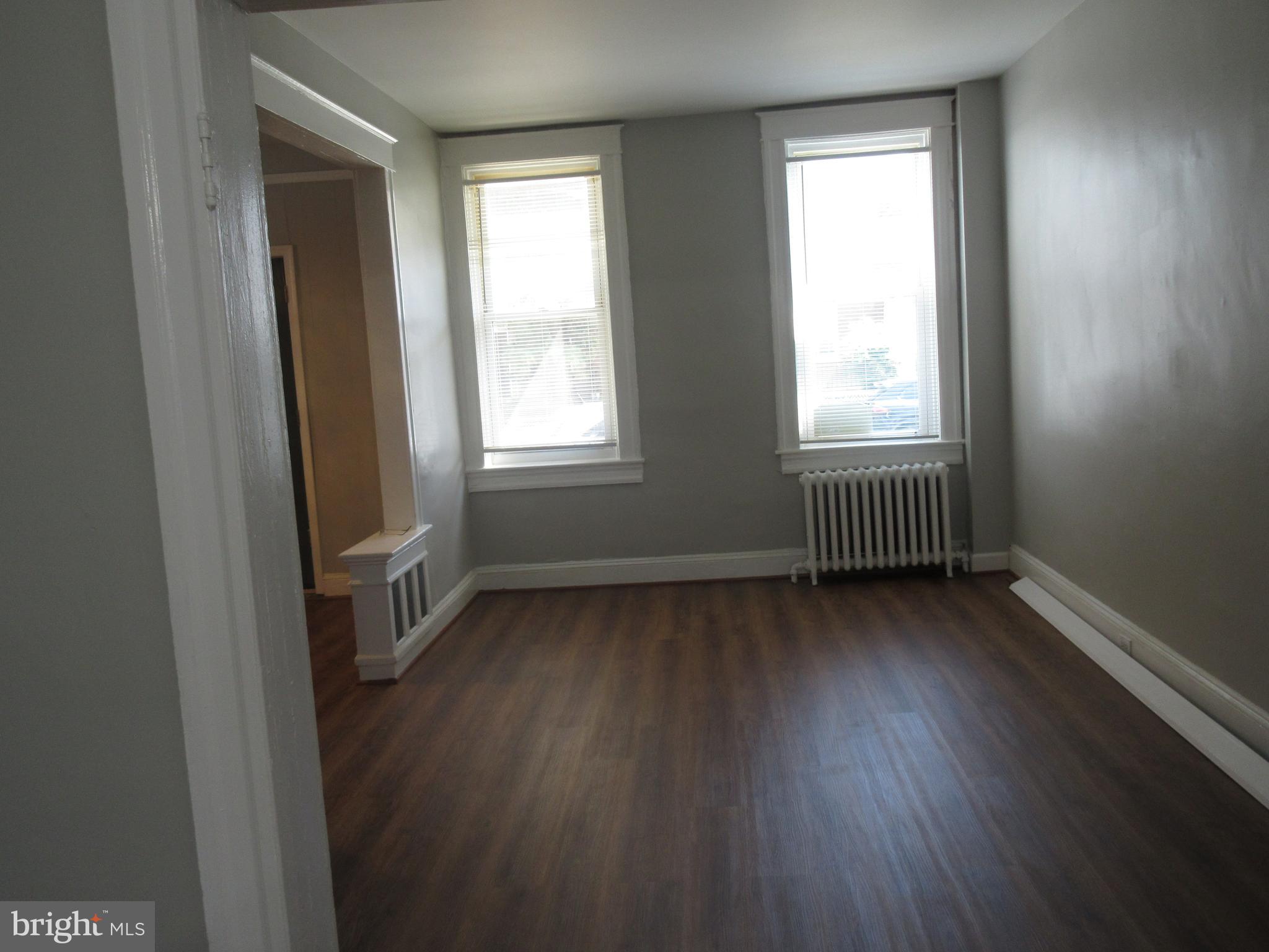 722 Edgewood Street Baltimore, MD 21229 - Photo 15 of 56 an empty room with wooden floor and windows