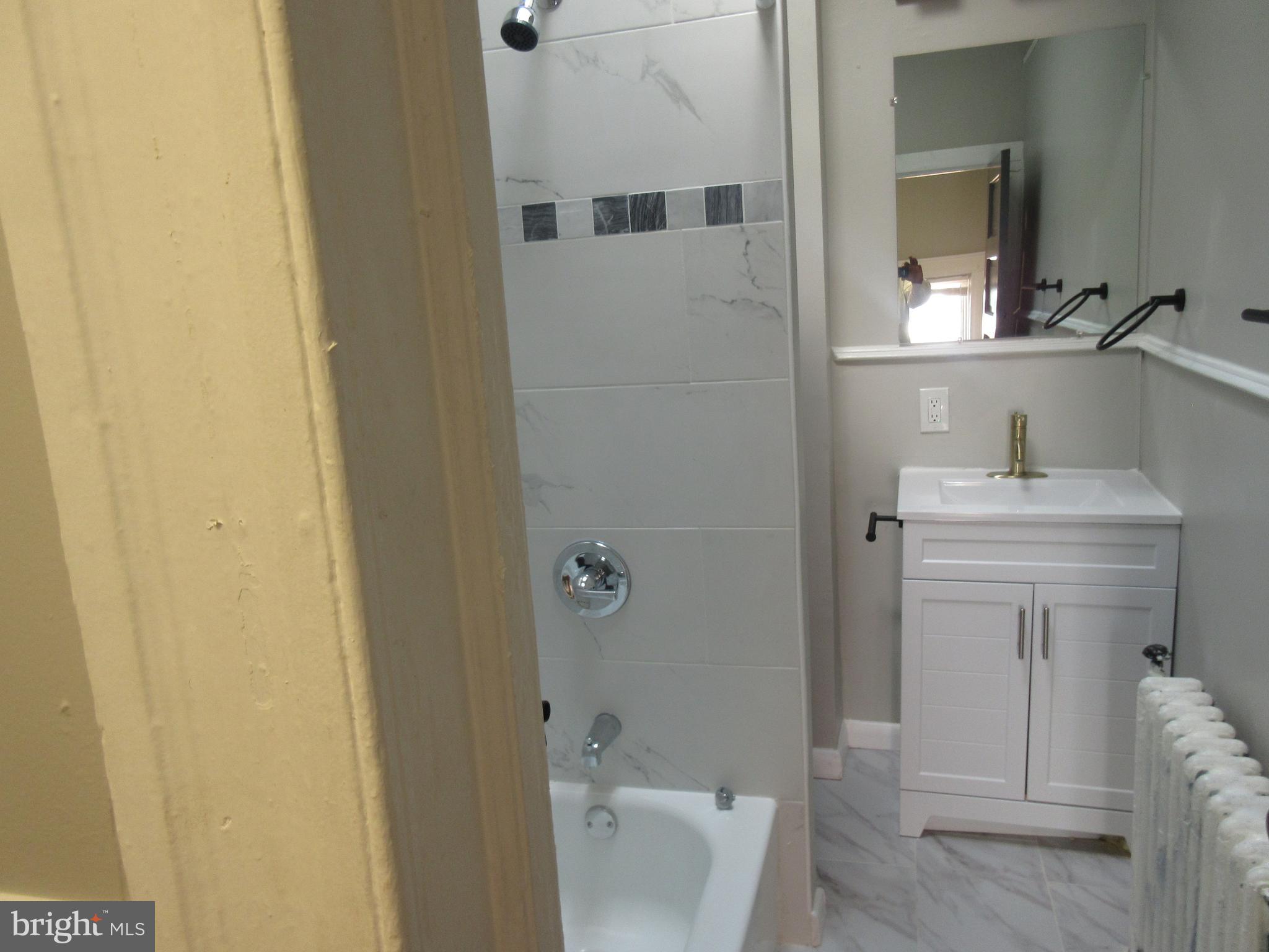 722 Edgewood Street Baltimore, MD 21229 - Photo 22 of 56 a bathroom with a sink toilet and shower