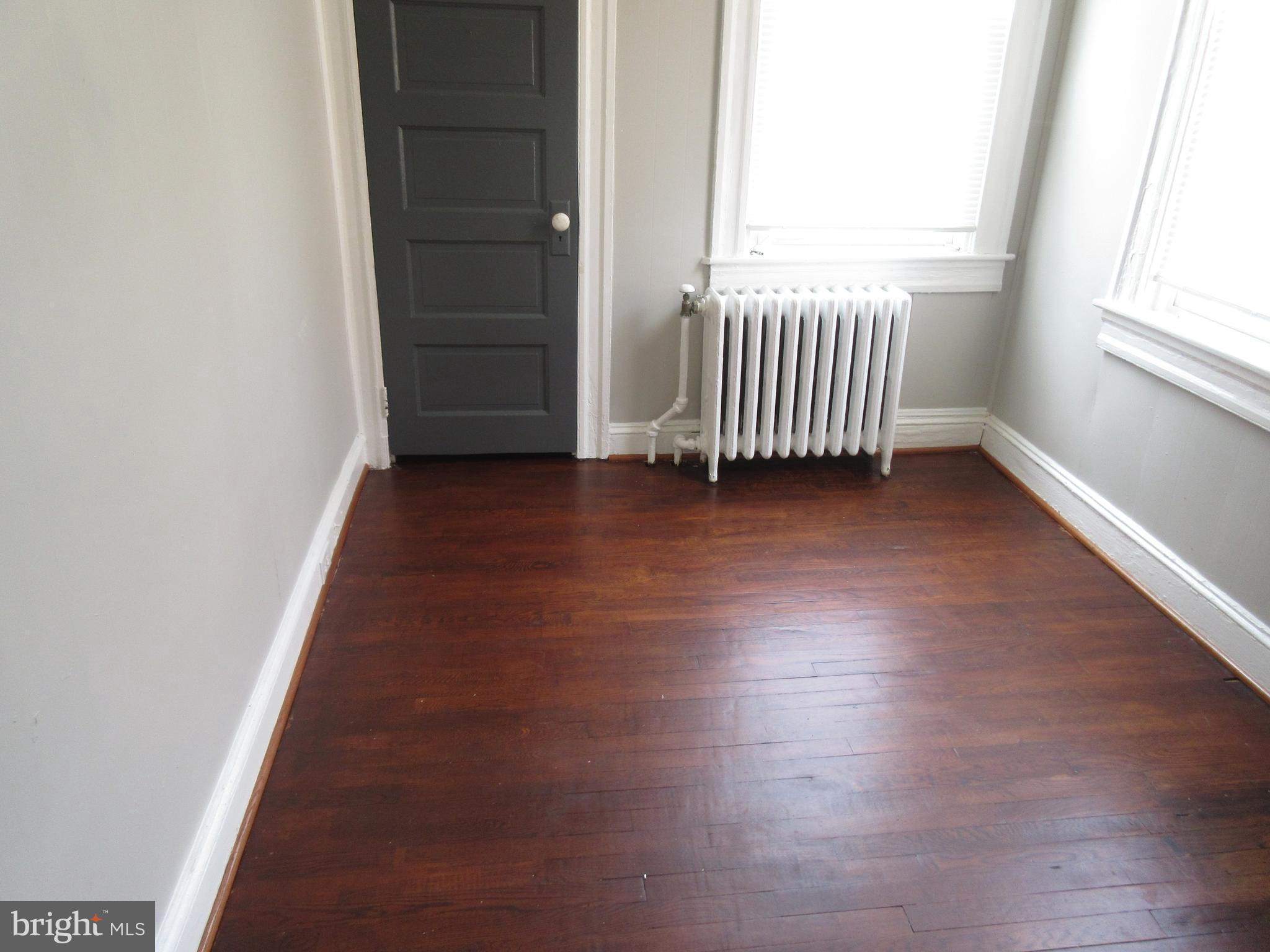 722 Edgewood Street Baltimore, MD 21229 - Photo 25 of 56 an empty room with wooden floor and windows