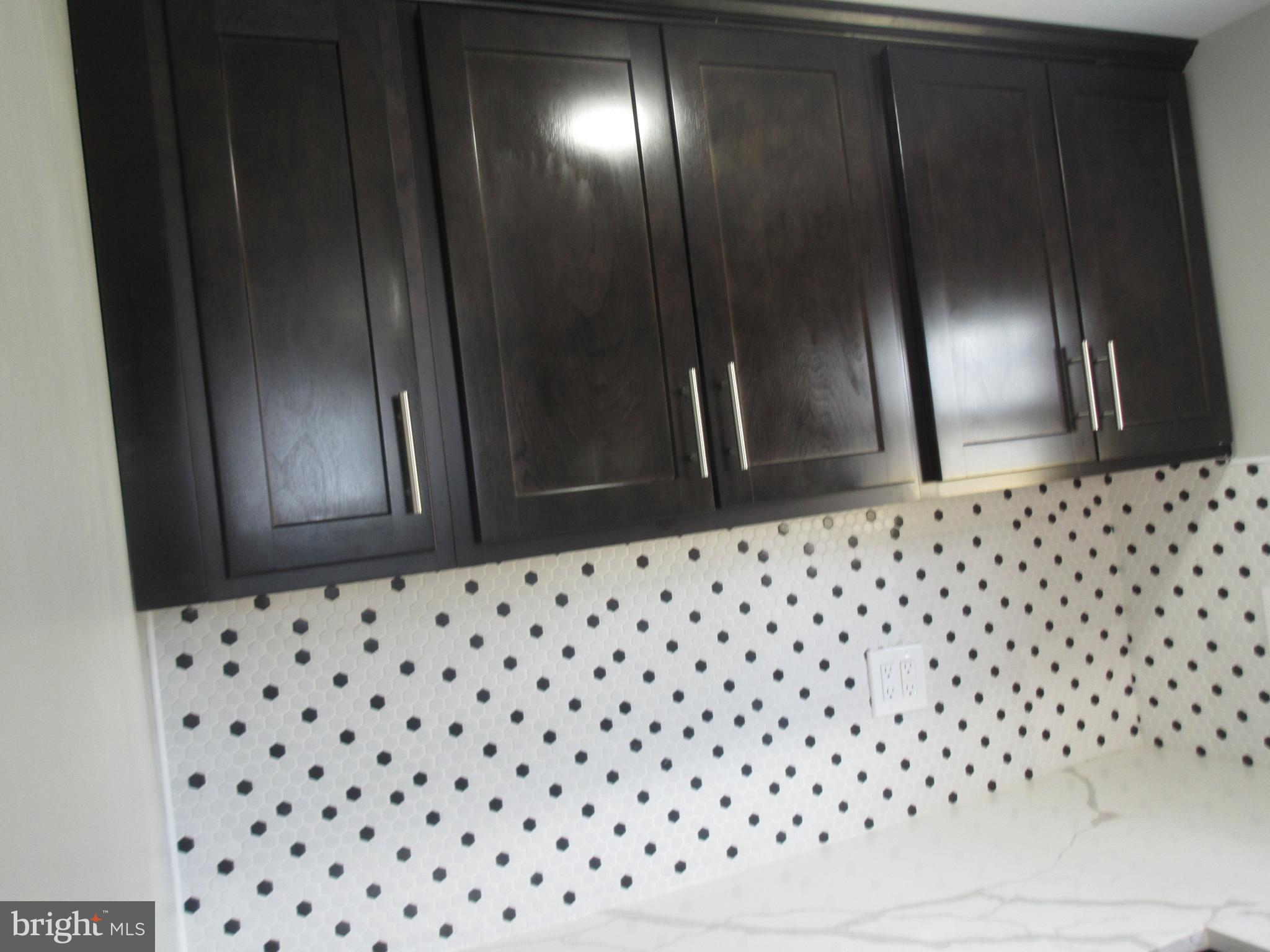 722 Edgewood Street Baltimore, MD 21229 - Photo 30 of 56 a bathroom with a sink a mirror and shower