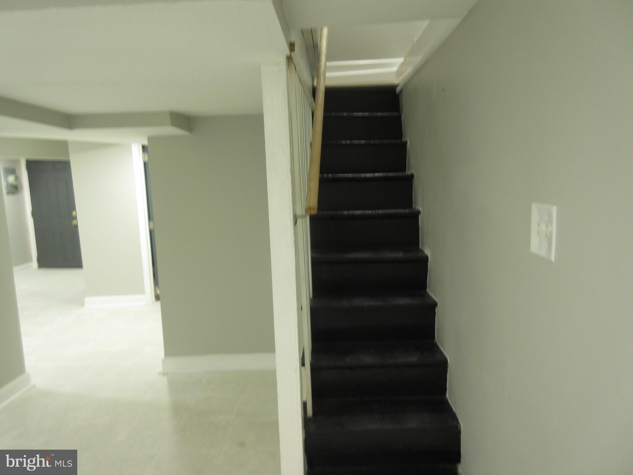722 Edgewood Street Baltimore, MD 21229 - Photo 32 of 56 a view of hallway with stairs and a white cabinet