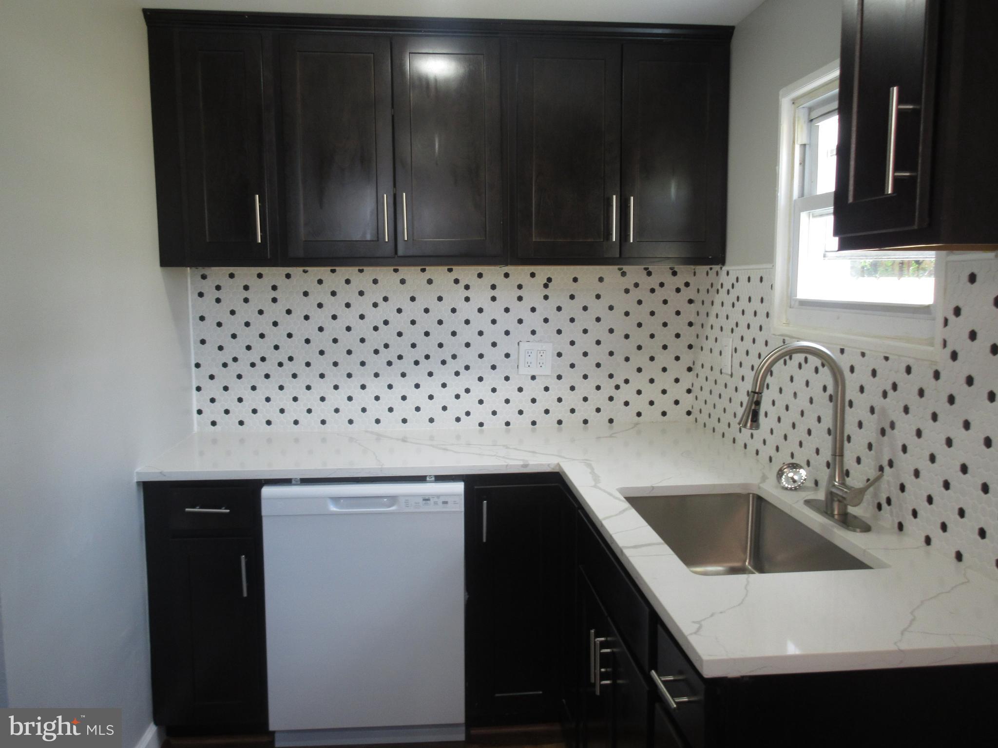 722 Edgewood Street Baltimore, MD 21229 - Photo 4 of 56 a kitchen with a sink and cabinets