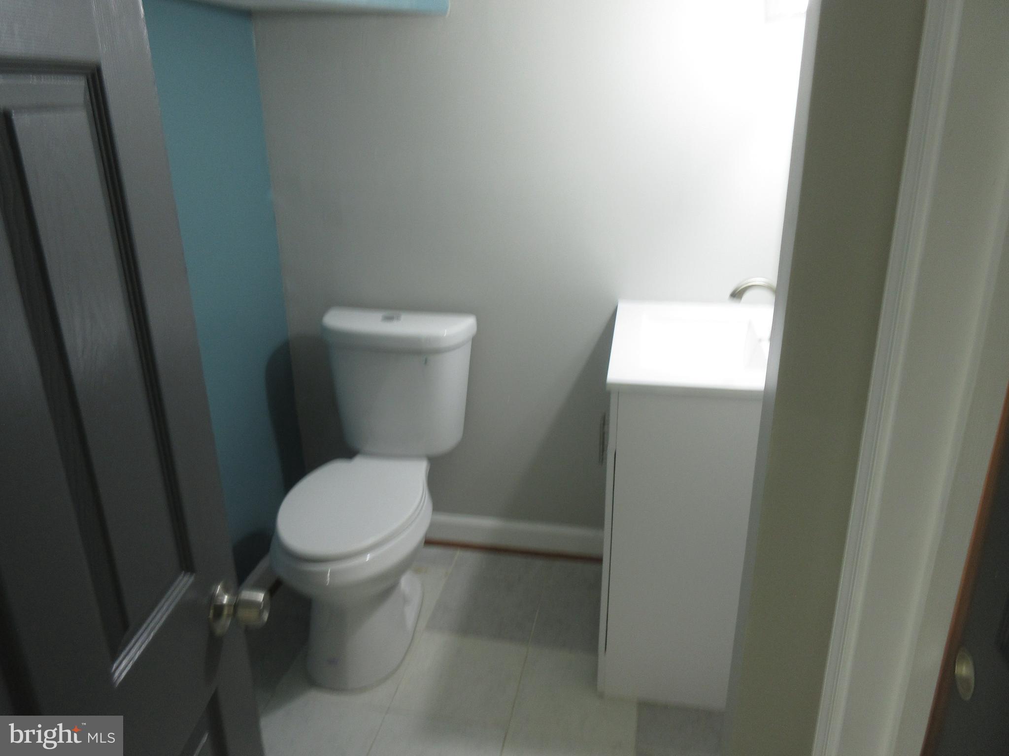 722 Edgewood Street Baltimore, MD 21229 - Photo 43 of 56 a white toilet sitting next to a sink