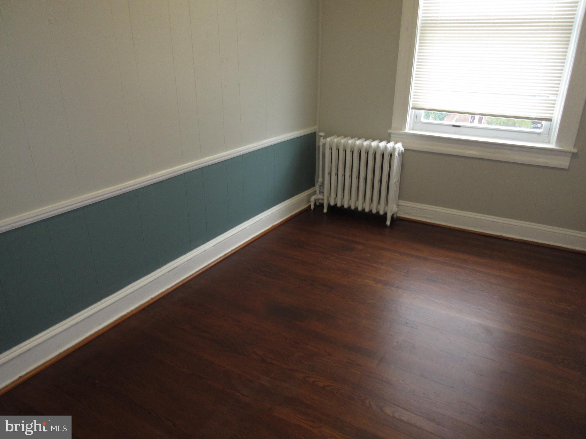722 Edgewood Street Baltimore, MD 21229 - Photo 47 of 56 a view of a room with wooden floor and windows