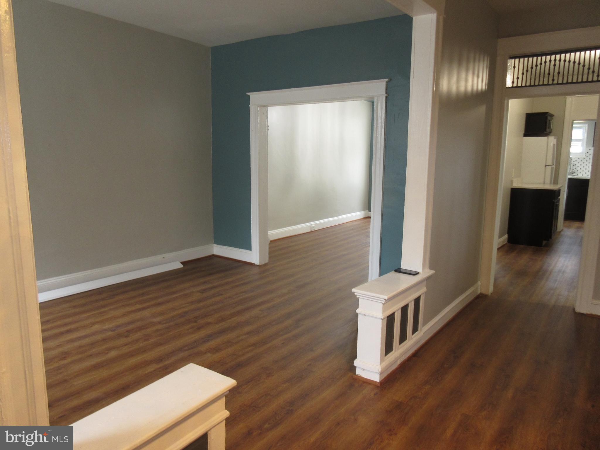 722 Edgewood Street Baltimore, MD 21229 - Photo 48 of 56 an empty room with wooden floor and windows