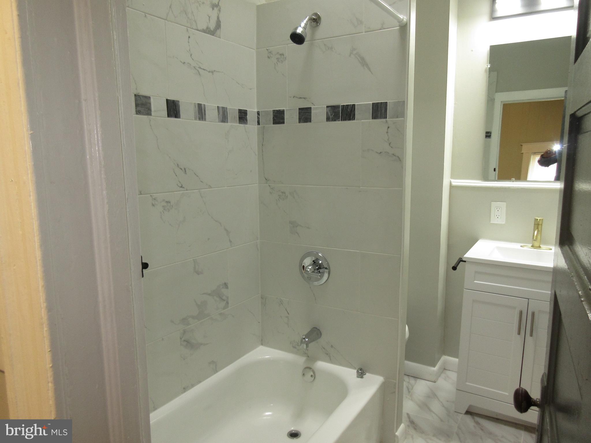 722 Edgewood Street Baltimore, MD 21229 - Photo 50 of 56 a bathroom with a sink and a shower