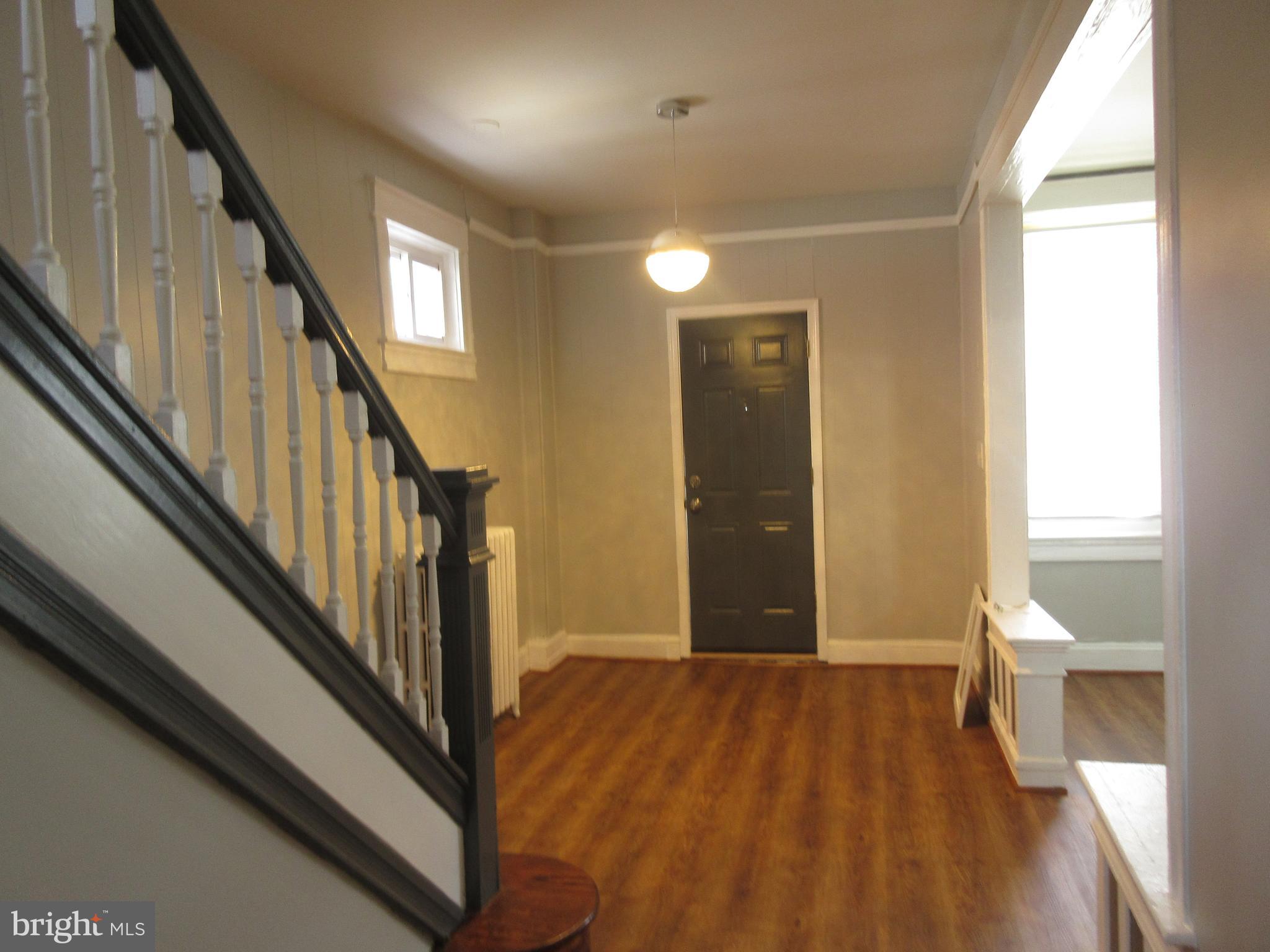 722 Edgewood Street Baltimore, MD 21229 - Photo 5 of 56 a view of a hallway with wooden floor and staircase