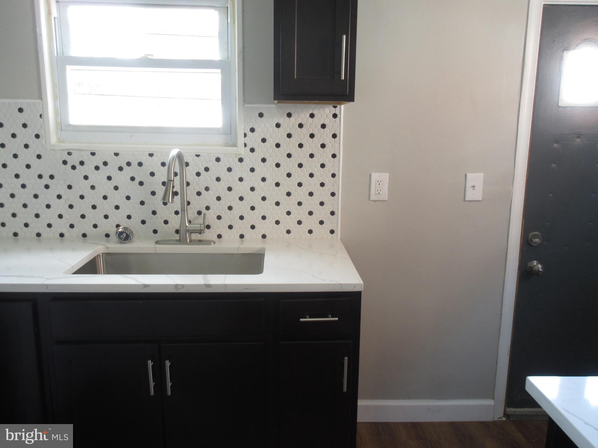 722 Edgewood Street Baltimore, MD 21229 - Photo 8 of 56 a bathroom with a sink a vanity and a window
