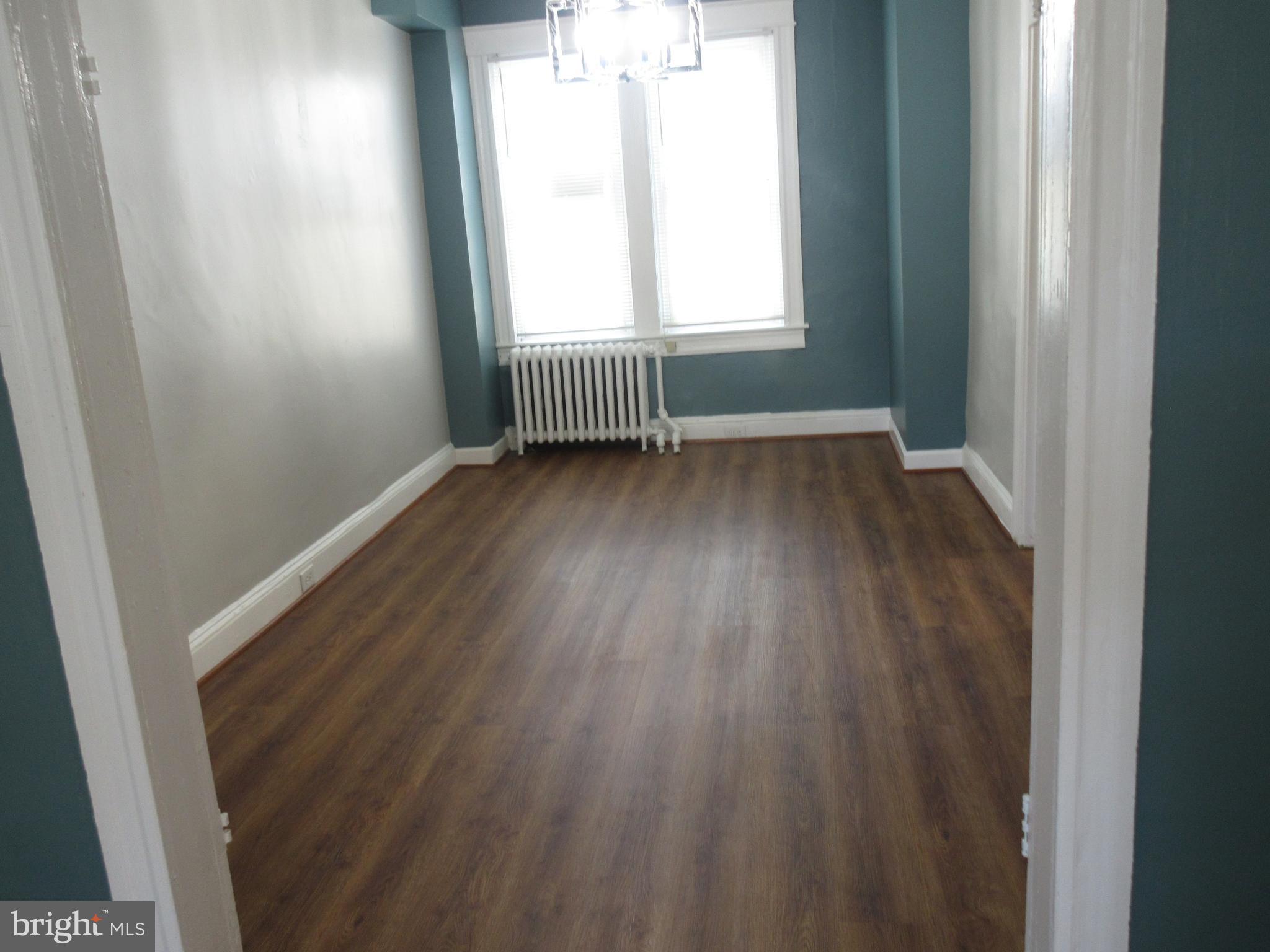 722 Edgewood Street Baltimore, MD 21229 - Photo 9 of 56 an empty room with wooden floor and windows