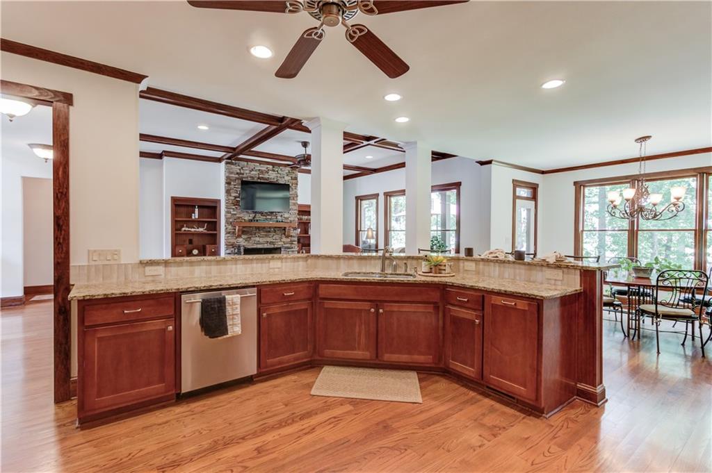 2240 Pear Grove Court Jefferson, GA 30549 - Photo 11 of 85 a large kitchen with stainless steel appliances granite countertop wooden cabinets a dining table and chairs