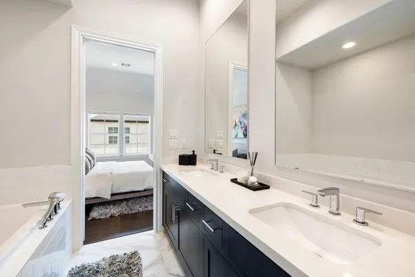 a bathroom with a bathtub and a rug